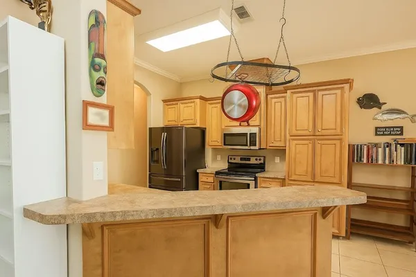 a kitchen with stainless steel appliances granite countertop a sink and a refrigerator
