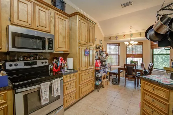 a kitchen with stainless steel appliances granite countertop a stove and cabinets