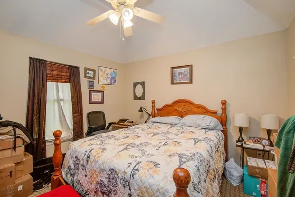 a bedroom with a bed and a chandelier
