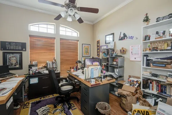 a room with furniture a bookshelf and a window