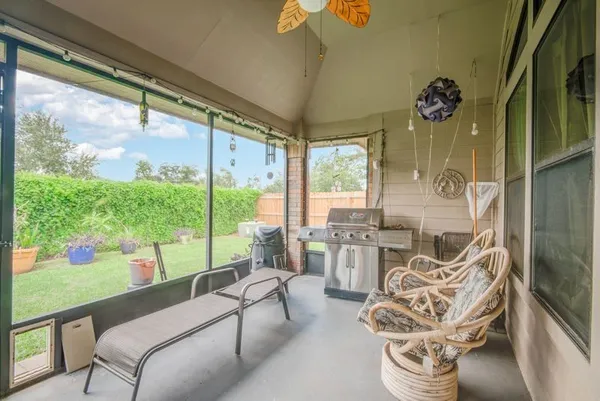 a living room with furniture and a floor to ceiling window