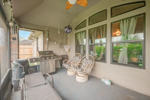 a living room with furniture a large window and a table