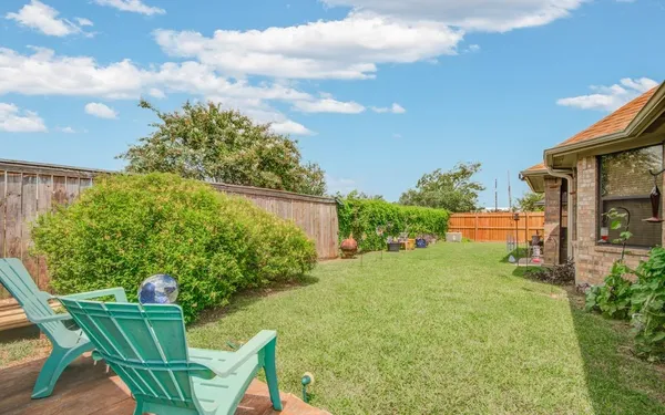 a view of an chairs and table in the garden