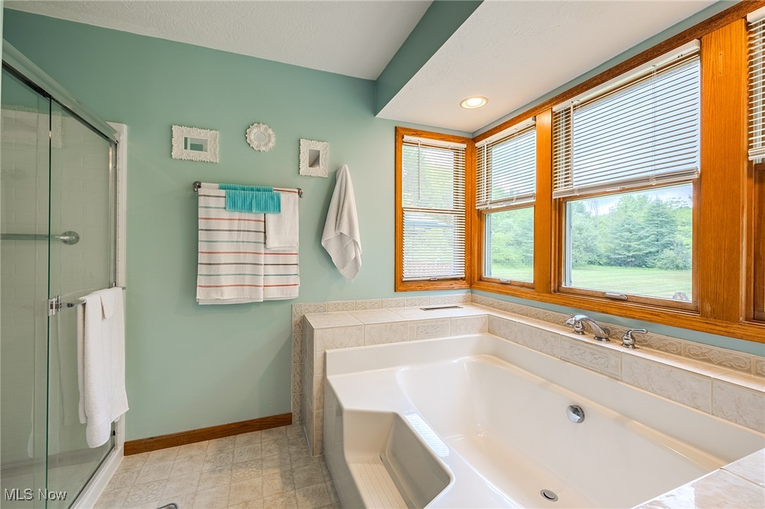 5691 Callahan Road Rome, OH 44085 - Photo 36 of 45 Full bath with a garden tub, a shower stall, and recessed lighting