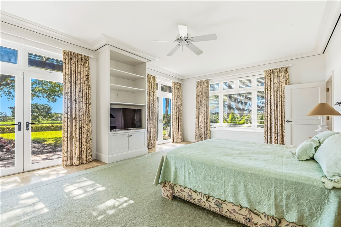2350 Quay Dock Road Vero Beach, FL 32967 - Photo 20 of 35 a spacious bedroom with a bed and glass door