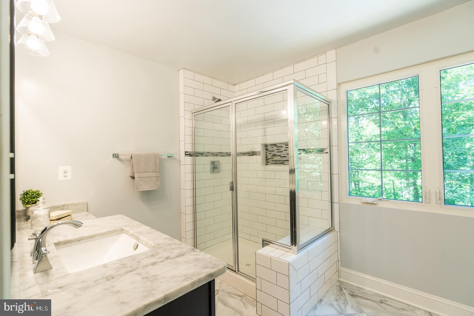 5705 Solomons Island Road St. Leonard, MD 20685 - Photo 24 of 46 a bathroom with a granite countertop sink a toilet and shower