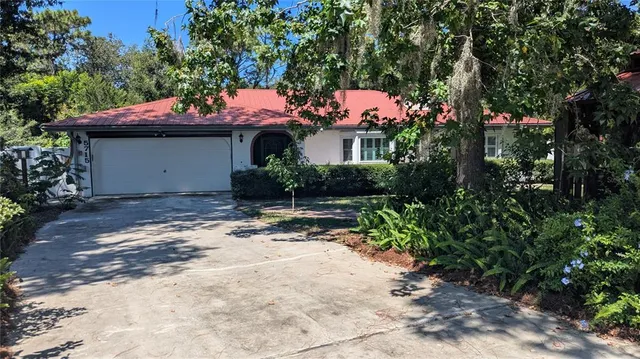 a front view of a house with a yard and a garage