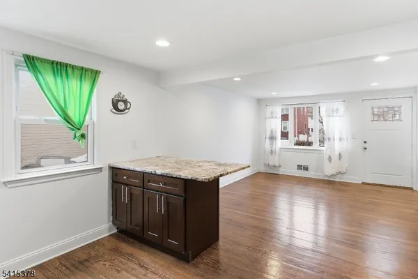 a kitchen with stainless steel appliances granite countertop a refrigerator stove microwave and sink