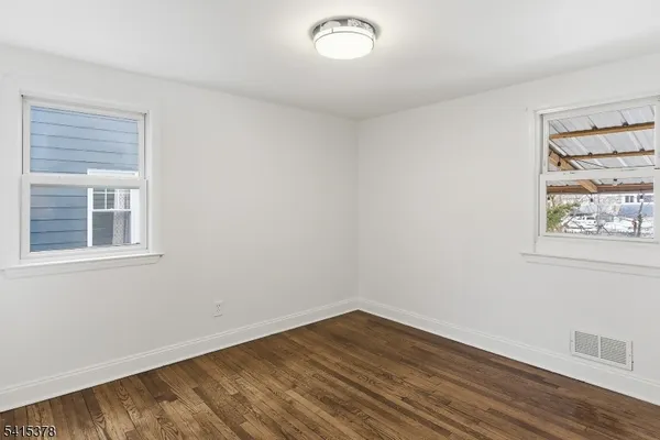 a view of a room with wooden floor and window