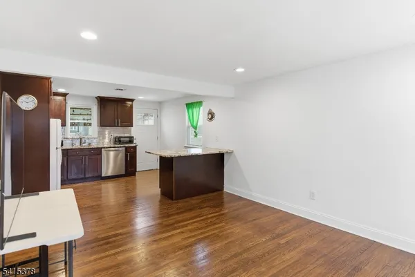 a kitchen with granite countertop a sink and a stove top oven