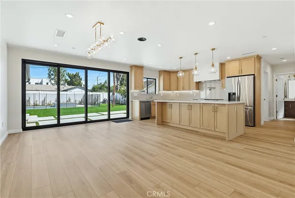 a view of a kitchen with wooden floor and a window