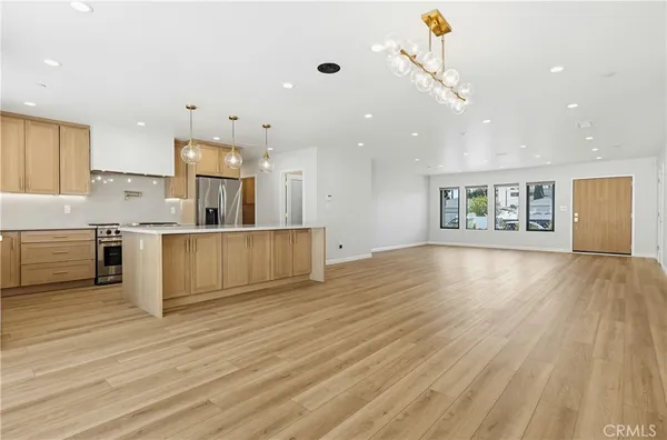 a view of kitchen with wooden floor and electronic appliances