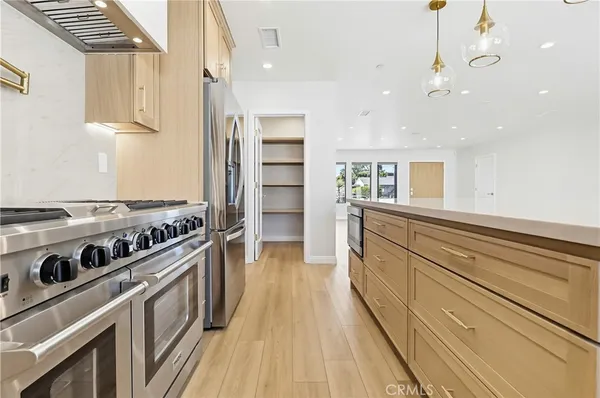 a kitchen with stainless steel appliances granite countertop a stove and a refrigerator