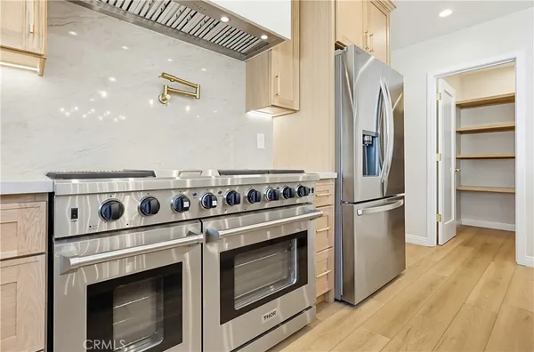 a kitchen with a stove and a refrigerator