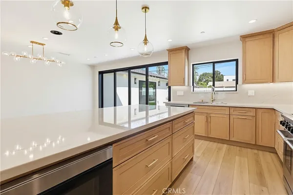 a large kitchen with kitchen island white cabinets and wooden floor