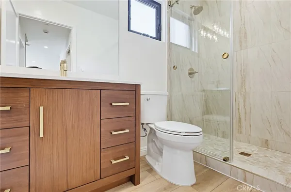 a bathroom with a sink a toilet and shower