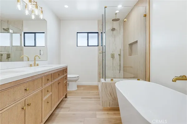 a spacious bathroom with a double vanity sink and a mirror