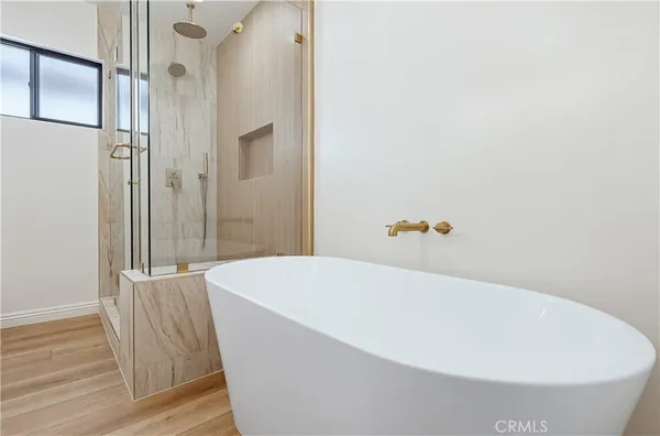 a white tub sitting next to a wooden wall