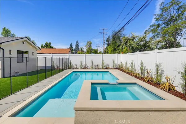 a view of swimming pool in front of yard