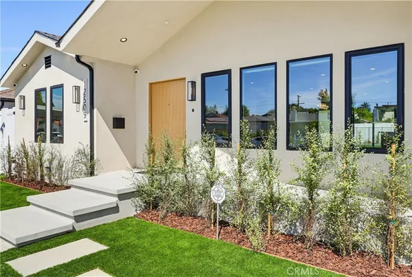 a view of house with backyard and outdoor seating