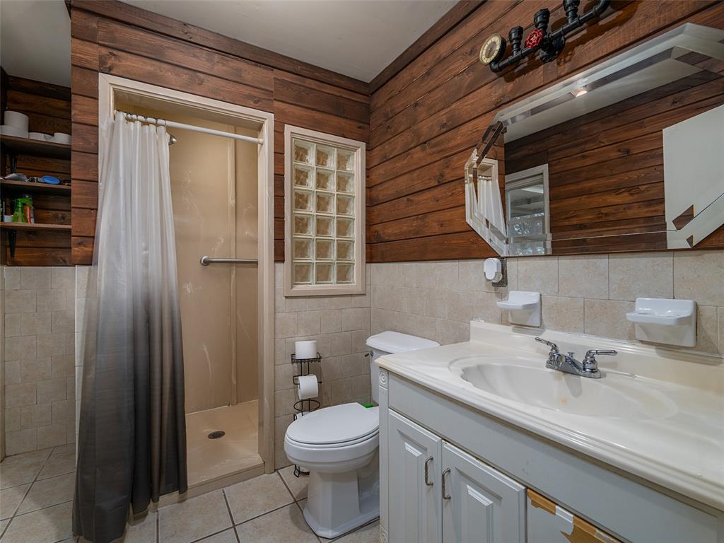 9663 Matise Street Tyler, TX 75706 - Photo 11 of 15 a bathroom with a sink a toilet and shower