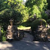 a backyard of a house with a yard and outdoor seating