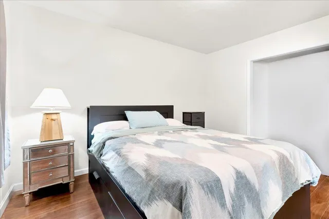 a bedroom with a bed and dresser