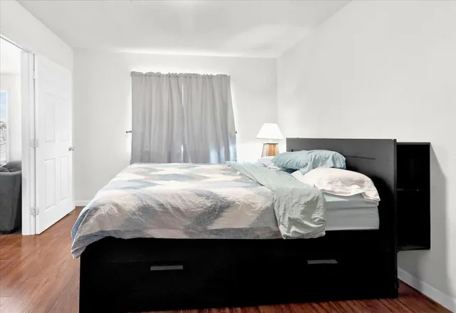 a bedroom with a bed and a night stand