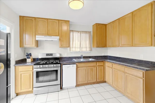 a kitchen with a stove a sink and a cabinets