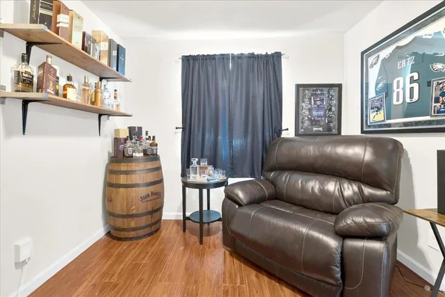 a living room with furniture and a hard wood floor