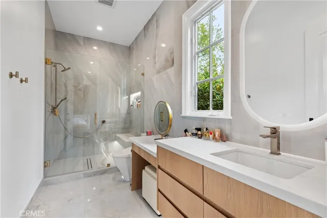 a bathroom with a double vanity sink mirror and shower