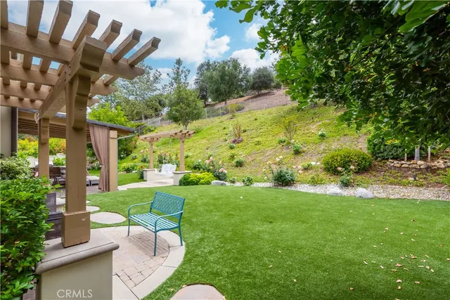 a view of backyard with seating area and green space