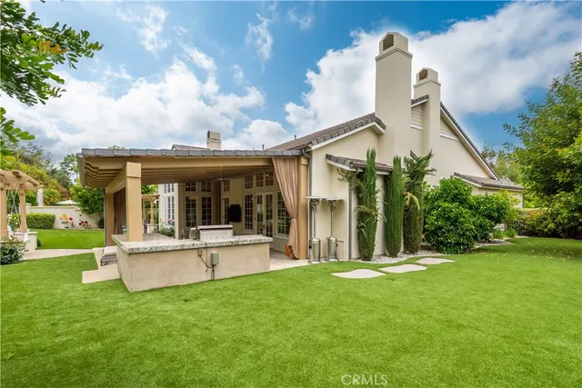 a view of a house with a yard and sitting area
