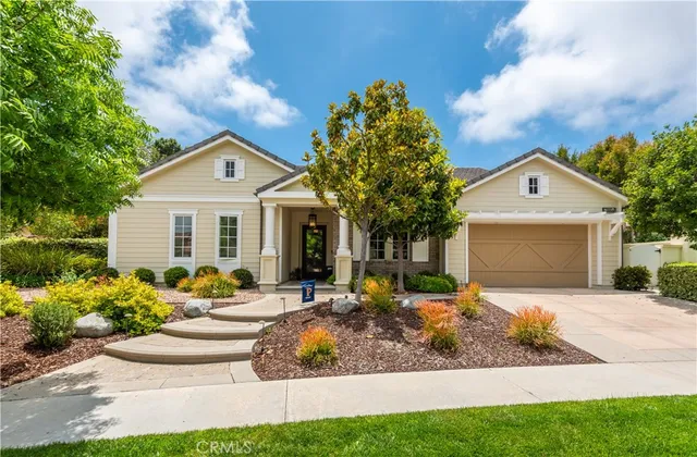 a front view of a house with yard and green space