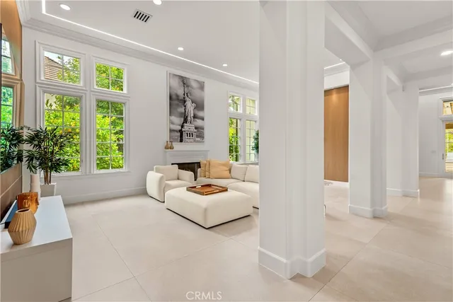 a living room with furniture and large windows