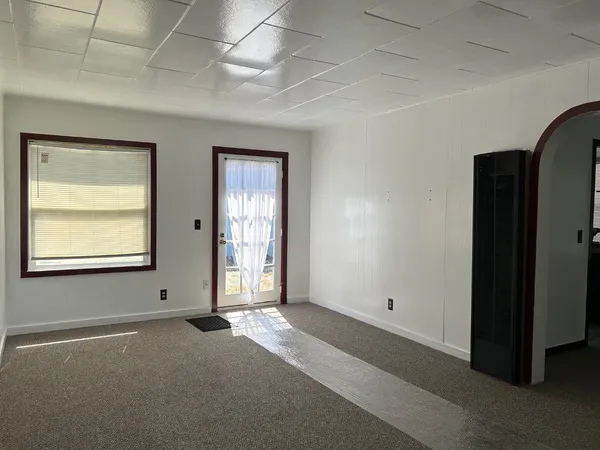 an empty room with windows and closet