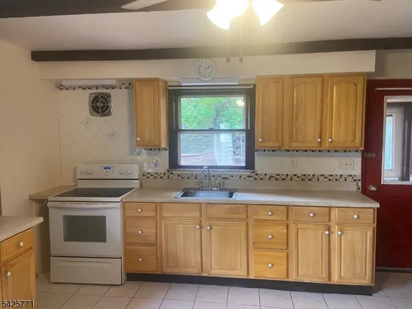 a kitchen with cabinets appliances and a window