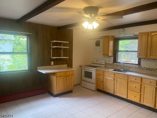 a spacious bathroom with a granite countertop sink and a mirror