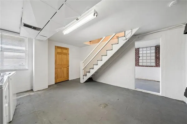 a view of an empty room with stairs