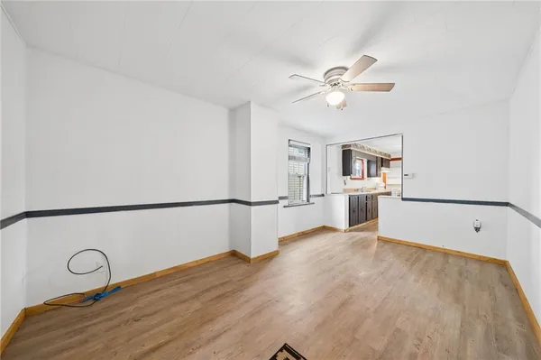 a view of a kitchen with a sink and a refrigerator