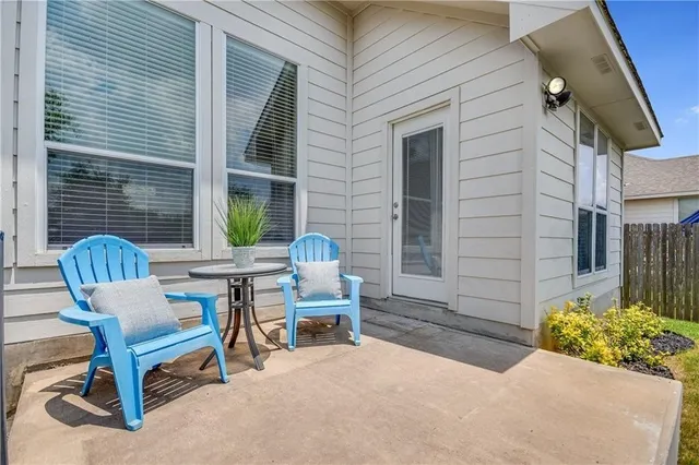 a wooden bench sitting in front of a house