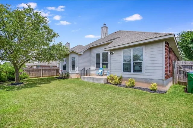 a front view of house with yard and outdoor seating