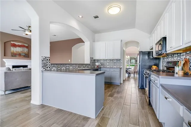 a kitchen with sink cabinets and wooden floor