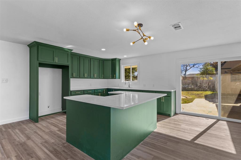 924 Whitestone Lane Dallas, TX 75232 - Photo 11 of 32 a kitchen with stainless steel appliances granite countertop a sink and a refrigerator