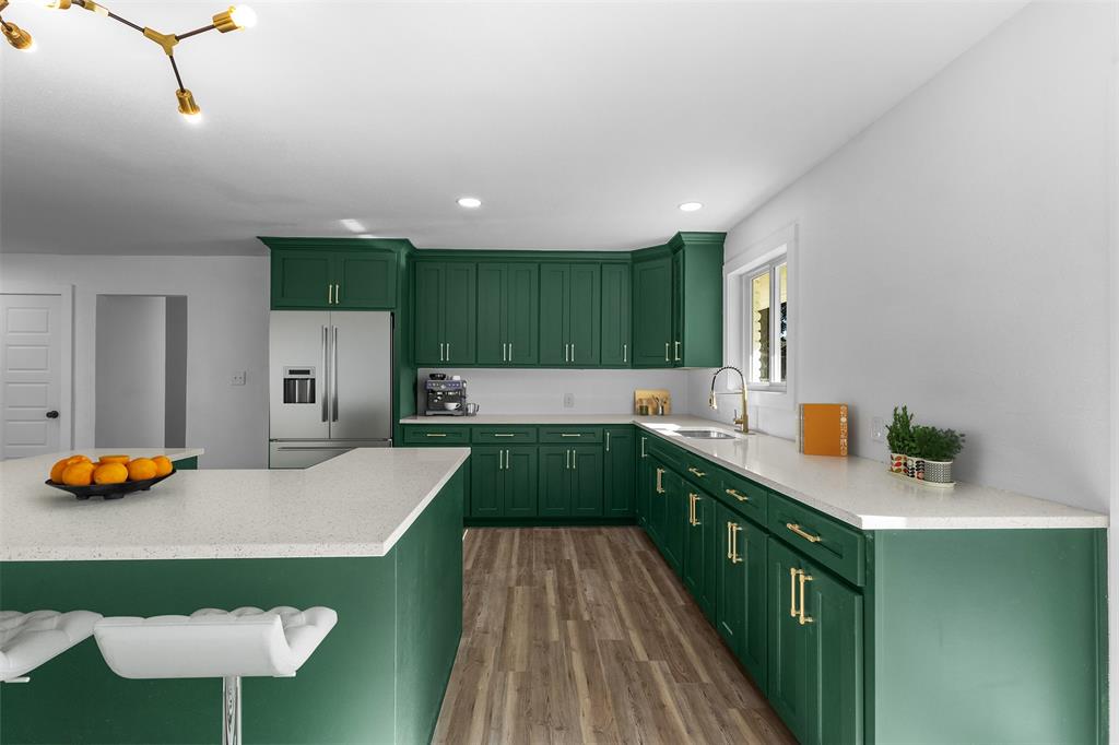 924 Whitestone Lane Dallas, TX 75232 - Photo 12 of 32 a kitchen with stainless steel appliances a sink stove and cabinets