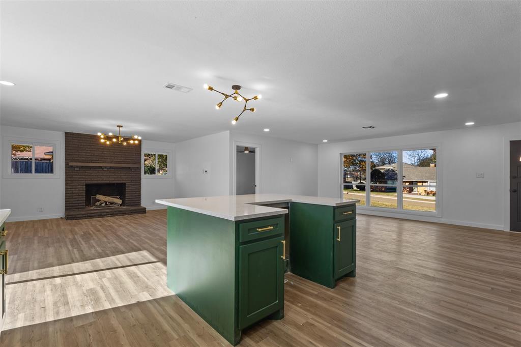 924 Whitestone Lane Dallas, TX 75232 - Photo 13 of 32 a kitchen with cabinets and a fireplace