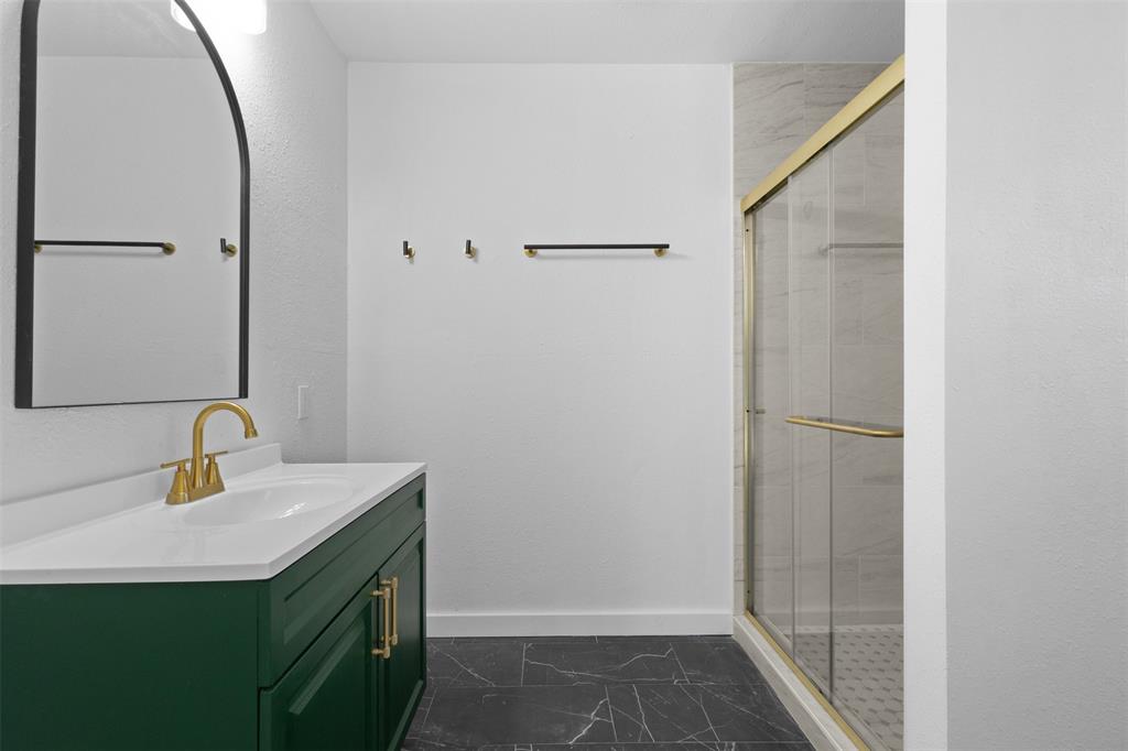 924 Whitestone Lane Dallas, TX 75232 - Photo 19 of 32 a bathroom with a sink and a mirror