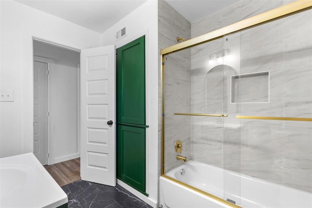 924 Whitestone Lane Dallas, TX 75232 - Photo 22 of 32 a bathroom with a bathtub and a shower