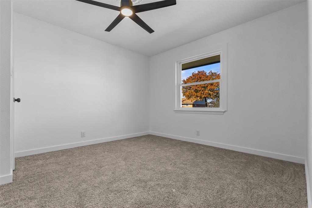 924 Whitestone Lane Dallas, TX 75232 - Photo 27 of 32 an empty room with a window and a ceiling fan