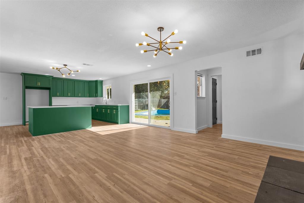 924 Whitestone Lane Dallas, TX 75232 - Photo 7 of 32 a view of an empty room with a fireplace and a window